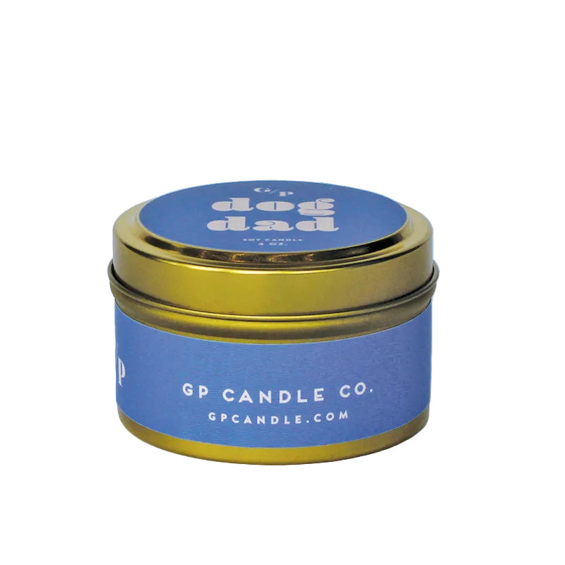 Sideview of 4 oz. purple candle tin with gold lid featuring 'dog dad' and GP Candle Co. logo on the side.
