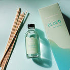 GP Candle Co. 4 oz Cloud diffuser with 8 natural reeds and packaging displaying the scent note "Violet Blossoms" on a light blue background.
