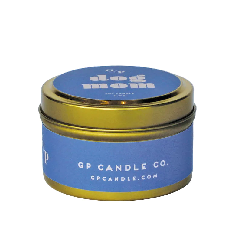 Sideview of 4 oz. lilac colored  candle tin with gold lid featuring 'dog mom' text and GP Candle Co. logo on the side.
