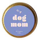 Top view of lilac colored  candle tin lid with 'dog mom' text and gold rim.