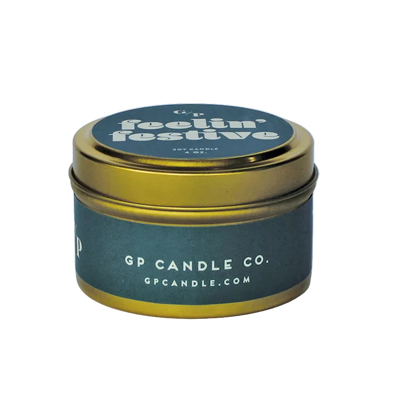 Sideview of 4 oz. teal candle tin with gold lid featuring 'festive af' and GP Candle Co. logo on the side.