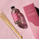GP Candle Co. 4 oz Flora diffuser with 8 natural reeds and packaging displaying the scent note "Wild Orchid" on a soft pink background.