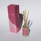 'Flora' glass reed diffuser with packaging on a white background.
